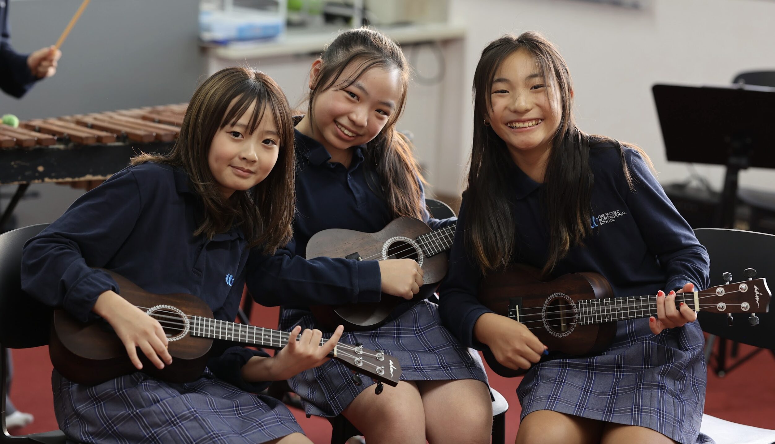 Female primary school Students playing ukulele in the music rooms