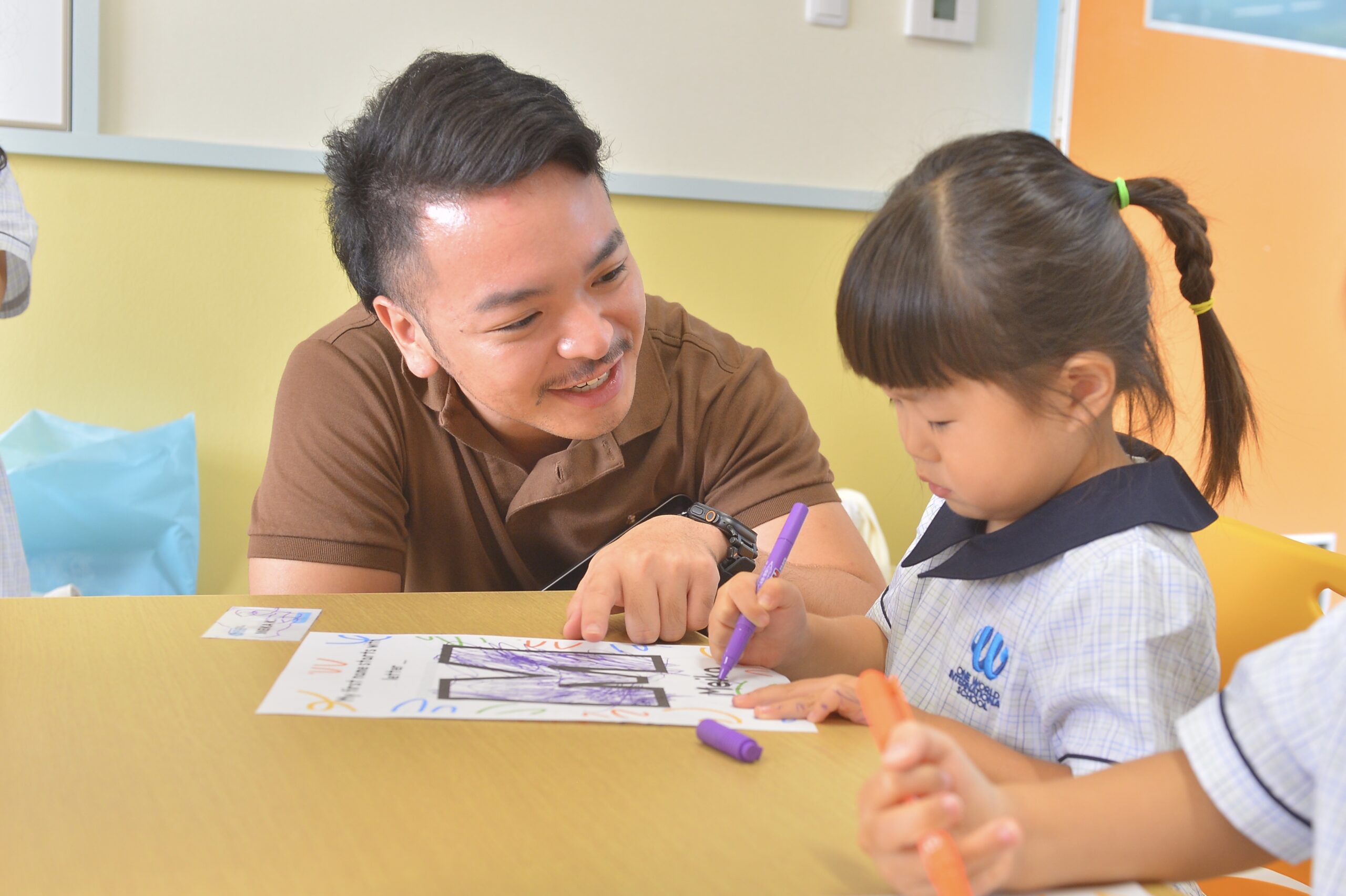 Early childhood student at One World International School Tsukuba gets assistance from the teacher in class
