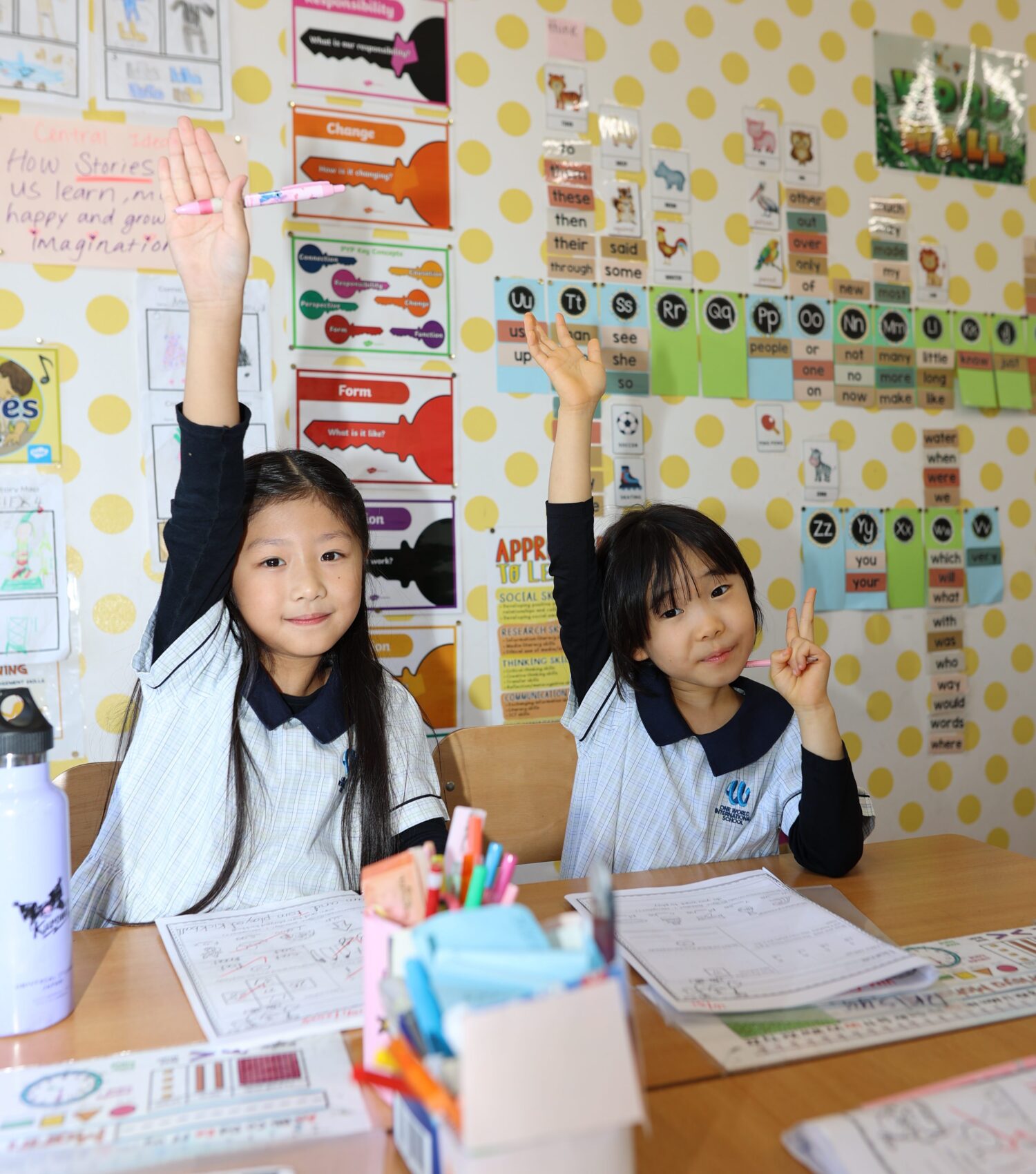 Transition Programme For April Starters - girls with their hand in the air ready to answer a question