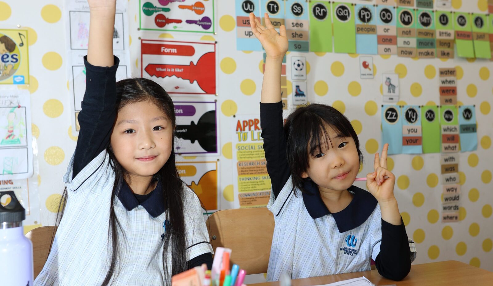 Transition Programme For April Starters - girls with their hand in the air ready to answer a question